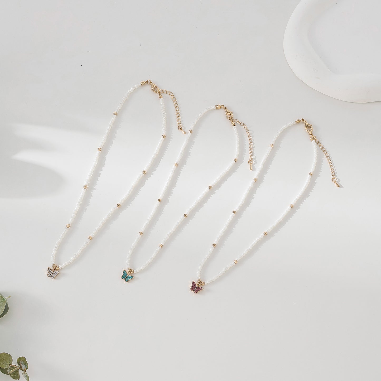 Assorted crystal Butterfly golden charm with small pearls and golden bead Necklace