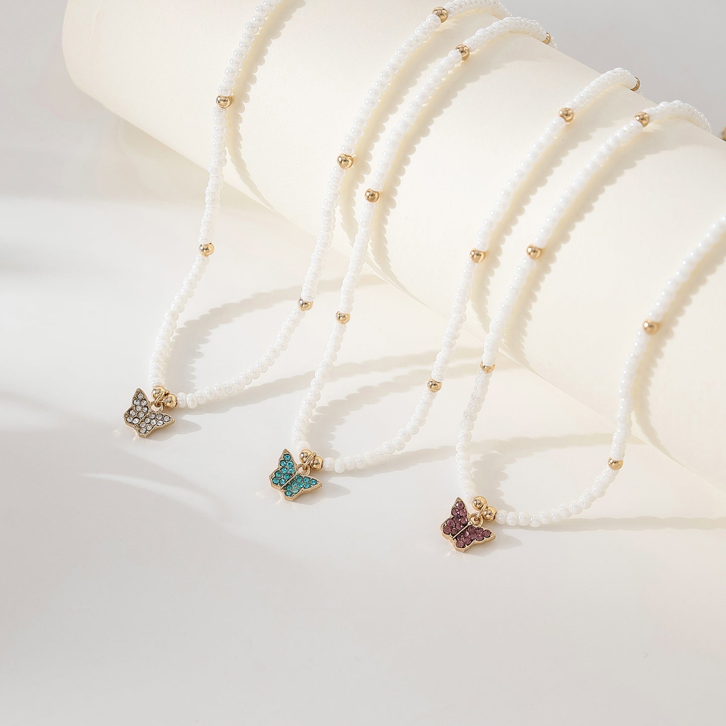 Assorted crystal Butterfly golden charm with small pearls and golden bead Necklace