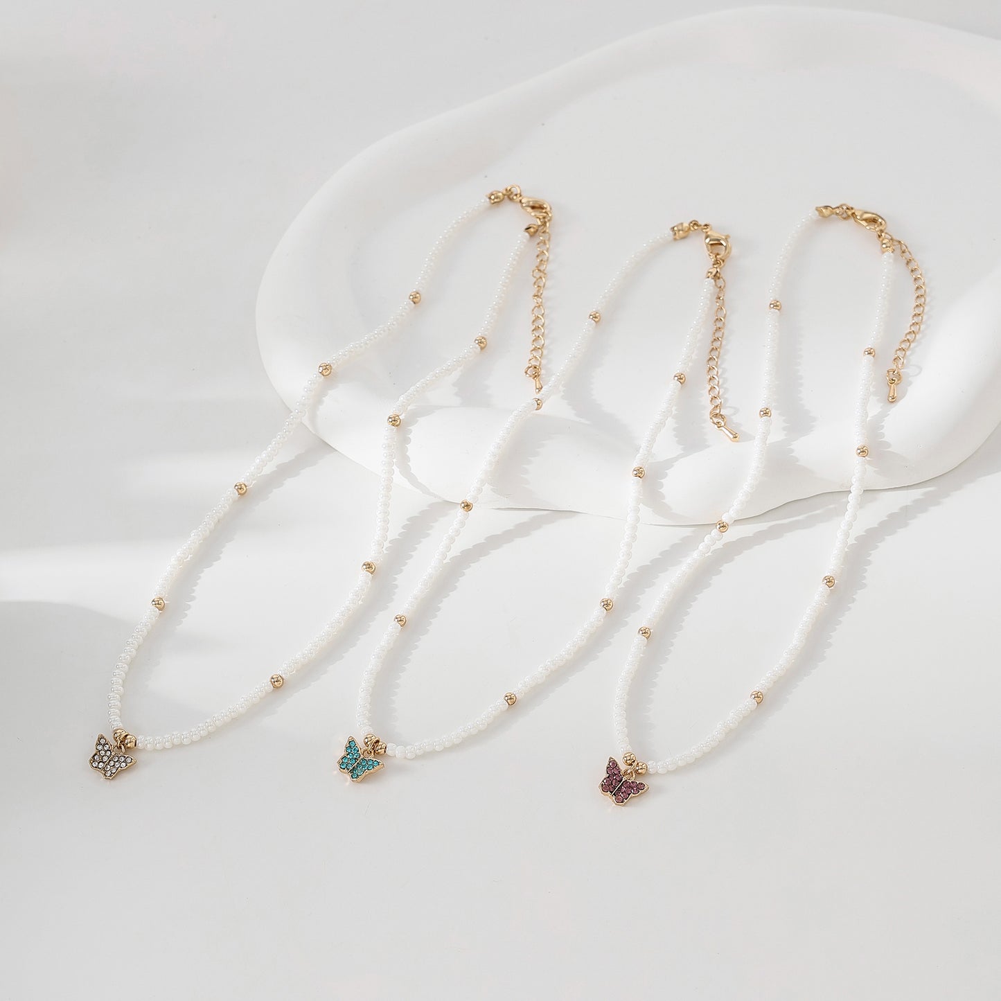 Assorted crystal Butterfly golden charm with small pearls and golden bead Necklace