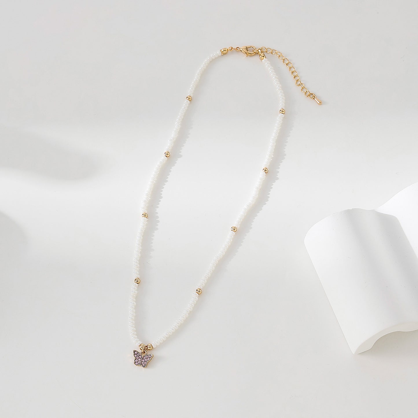 Assorted crystal Butterfly golden charm with small pearls and golden bead Necklace