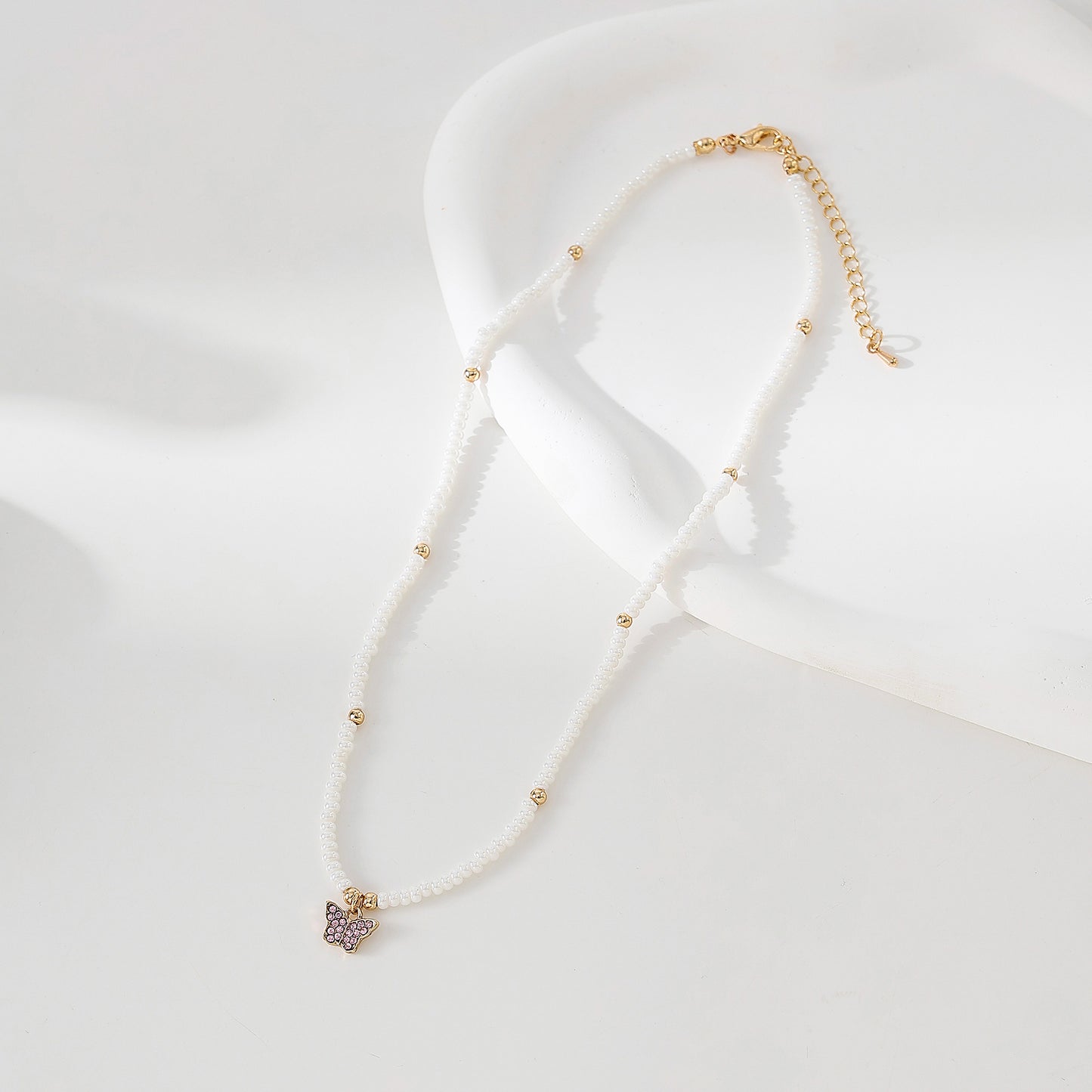 Assorted crystal Butterfly golden charm with small pearls and golden bead Necklace