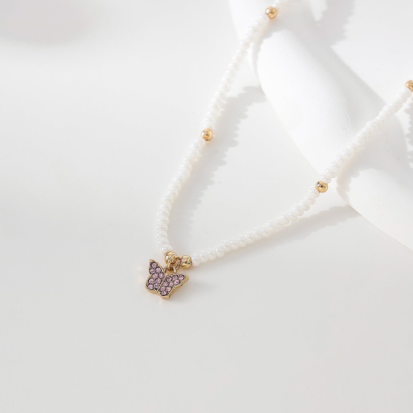 Assorted crystal Butterfly golden charm with small pearls and golden bead Necklace