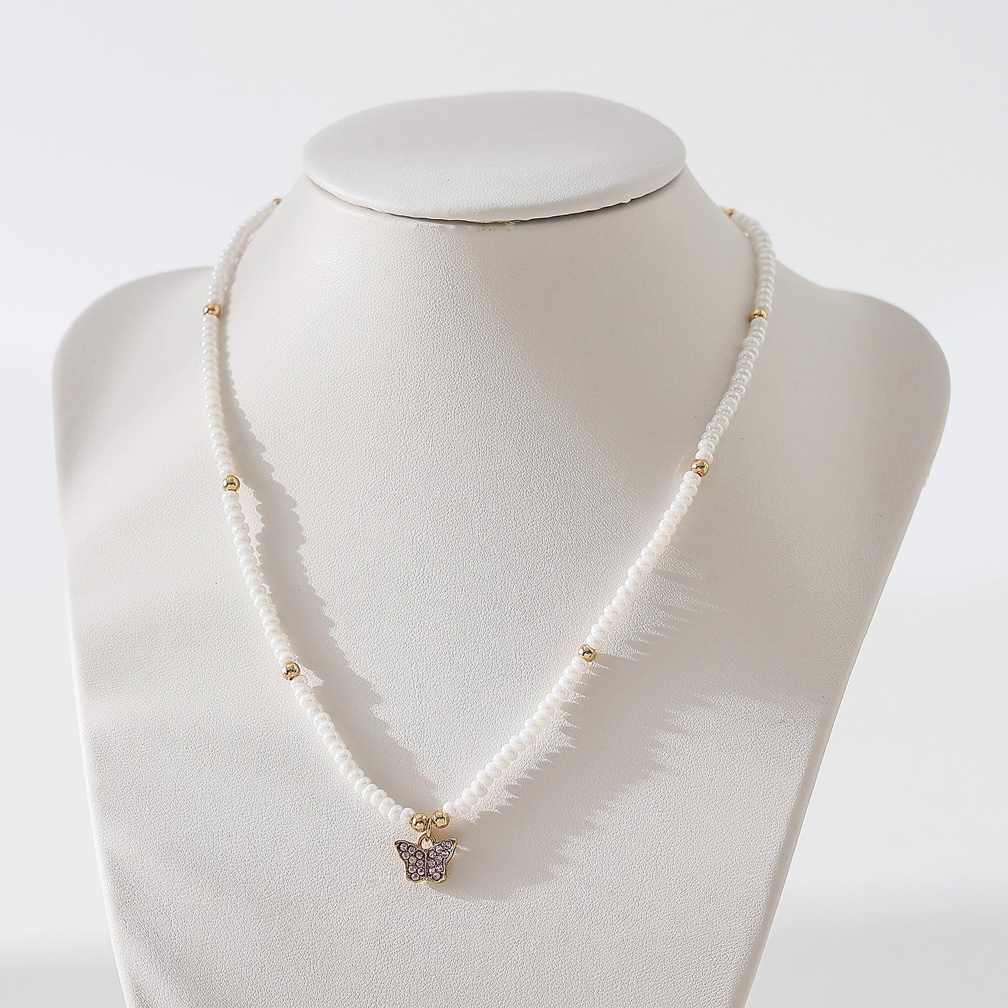 Assorted crystal Butterfly golden charm with small pearls and golden bead Necklace